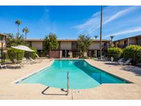 Inviting community pool with lounge chairs and patio umbrellas at 4701 N 68Th St # 248, Scottsdale, AZ 85251