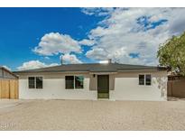 Newly renovated single-story home with a neutral color palette and a gravel driveway at 5001 S 20Th St, Phoenix, AZ 85040