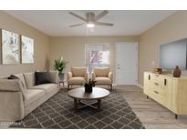 Bright living room featuring a neutral color palette, plush sofa, and two armchairs at 1340 N Recker Rd # 131, Mesa, AZ 85205