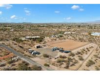 Aerial view of a sprawling property with a large house, arena, and surrounding desert landscape at 501 S Saguaro Dr, Wickenburg, AZ 85390