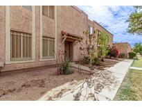 Front view of a light brown stucco condo with a walkway and landscaping at 8428 N 33Rd Dr, Phoenix, AZ 85051