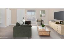 Bright living room featuring a sofa, armchair, and coffee table at 1340 N Recker Rd # 256, Mesa, AZ 85205
