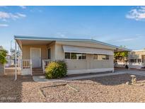 Single-wide manufactured home with carport and landscaped yard at 2650 W Union Hills Dr # 155, Phoenix, AZ 85027