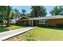 House exterior showcasing a walkway to the front door, and a well-manicured lawn at 1011 W Northern Ave, Phoenix, AZ 85021