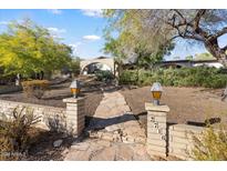 Inviting front yard with stone pathway leading to a charming single-story home at 2716 E Voltaire Ave, Phoenix, AZ 85032