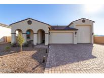 Two-story house with a three-car garage and landscaped front yard at 5203 W Roundhouse Rd, Laveen, AZ 85339
