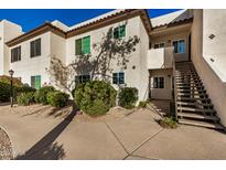 Well-maintained condo building with attractive landscaping and convenient staircase access at 9450 E Becker Ln # 1094, Scottsdale, AZ 85260