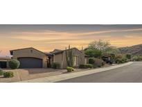 Stunning curb appeal featuring a two-car garage and desert landscaping at 25995 N 85Th Dr, Peoria, AZ 85383