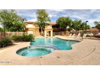 Community pool and spa with surrounding lounge chairs at 1445 E Broadway Rd # 120, Tempe, AZ 85282
