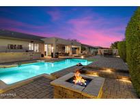 Expansive backyard oasis featuring a pool, fire pit, and patio at 4326 E Zenith Ln, Cave Creek, AZ 85331