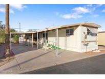 Single-wide manufactured home with covered porch and paved driveway at 530 S Alma School Rd # 37, Mesa, AZ 85210