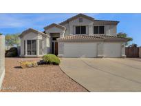 Two-story house with three car garage and desert landscaping at 1328 E Cottonwood Ln, Phoenix, AZ 85048