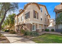 Exterior of charming townhome with stone accents and landscaping at 888 W Aspen Way, Gilbert, AZ 85233