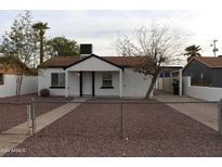 Charming bungalow with a newly renovated exterior and a well-maintained front yard at 1637 W Garfield St, Phoenix, AZ 85007