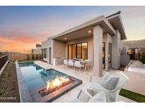 Inviting backyard oasis with a rectangular pool, fire pit, and patio furniture at 14174 E Highland Ave, Fountain Hills, AZ 85268