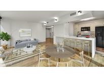 Open concept dining area with kitchen access and modern wood table at 4808 N 24Th St # 531, Phoenix, AZ 85016