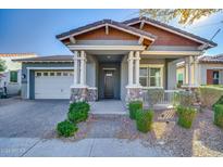 Craftsman style home with front porch and landscaped yard at 10535 E Palladium Dr, Mesa, AZ 85212