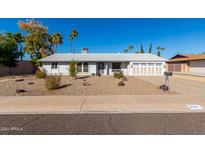 Single story home with landscaped front yard, two-car garage, and neutral color palette at 224 E Eugie Ave, Phoenix, AZ 85022