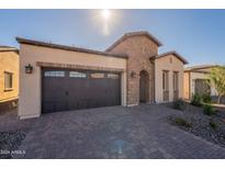 Single-story home with brick accents and a two-car garage at 375 E Bracciano Ave, Queen Creek, AZ 85140