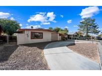 Front view of a single-story home with a curved driveway and desert landscaping at 1219 E Barcelona Ave, Casa Grande, AZ 85122