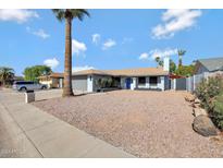Updated single-level home with desert landscaping and a large driveway at 4832 W Caron St, Glendale, AZ 85302