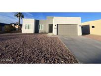 Modern stucco home with two-car garage and desert landscaping at 1298 W Calle Tuberia --, Casa Grande, AZ 85194