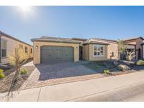 Single-story home with a two-car garage and landscaped front yard at 389 E Bracciano Ave, Queen Creek, AZ 85140