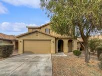 Two-story house with a tan facade, a two-car garage, and a landscaped front yard at 4042 W Kirkland Ave, San Tan Valley, AZ 85144