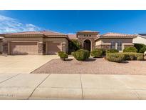 One-story home with stone accents, two-car garage, and landscaped front yard at 17892 N Bridle Ln, Surprise, AZ 85374