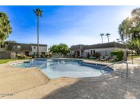 Community pool with lounge chairs and palm trees at 4937 N Granite Reef Rd, Scottsdale, AZ 85251