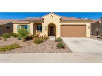 Single-story home with a two-car garage and nicely landscaped front yard at 7266 W Meadowlark Way, Florence, AZ 85132