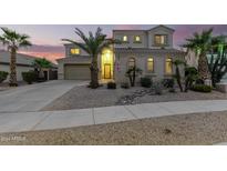 Two-story house with a landscaped yard, large windows, and a three-car garage at 17881 W Larkspur Dr, Surprise, AZ 85388
