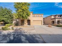 Two-story house with a two-car garage and mature landscaping at 21128 E Tierra Grande Dr, Queen Creek, AZ 85142