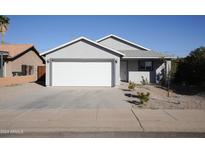 Newly constructed home with a two-car garage and well-maintained landscaping at 10810 W Torren Dr, Arizona City, AZ 85123