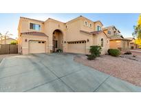 Two-story house with a three-car garage and landscaping at 17769 W Alexandria Way, Surprise, AZ 85388