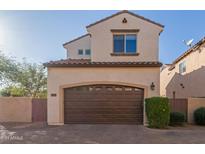 Attached garage with brown overhead door at 2004 E Heartwood Ln, Phoenix, AZ 85022