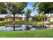 Tranquil backyard oasis with water feature and lush landscaping at 2232 W Lindner Ave # 44, Mesa, AZ 85202