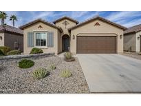 Single-story home with a two-car garage and desert landscaping at 4110 W Winslow Way, Eloy, AZ 85131