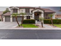 Two-story home with a three-car garage and manicured landscaping at 4458 S Marion Pl, Chandler, AZ 85249