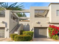 Two-story condo building with attached garage and landscaping at 7710 E Gainey Ranch Rd # 157, Scottsdale, AZ 85258