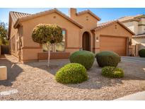 One-story house with landscaped yard, two-car garage, and desert landscaping at 45759 W Morning View Ln, Maricopa, AZ 85139