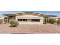 Front view of a single-story manufactured home with a covered carport at 8140 E Cactus Dr, Mesa, AZ 85208