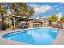 Relaxing backyard oasis featuring a sparkling pool and patio furniture at 2328 N Roca St, Mesa, AZ 85213