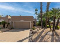 Tan stucco house with a two-car garage and desert landscaping at 25515 N Forest Rd # 1, Rio Verde, AZ 85263