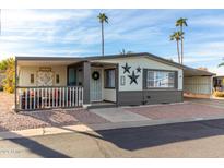Inviting exterior of a manufactured home with a covered porch and landscaped yard at 3104 E Broadway Rd # 22, Mesa, AZ 85204