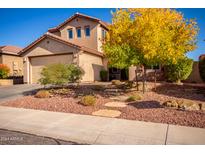 Two-story house with desert landscaping and a three-car garage at 43301 N National Trl, Anthem, AZ 85086