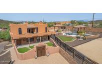 Stunning aerial view of a two-story home with a pool, putting green, and expansive backyard at 47012 N New River Rd, New River, AZ 85087