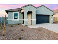 New single-story home with a two-car garage and desert landscaping at 12206 E Aster Ln, Florence, AZ 85132