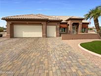 Beautiful single-story home with a large driveway and well-manicured lawn at 14632 W Ganado Dr, Sun City West, AZ 85375