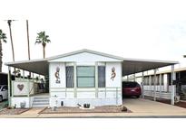 Single-wide manufactured home with covered carport and small front yard at 205 S Higley Rd # 218, Mesa, AZ 85206